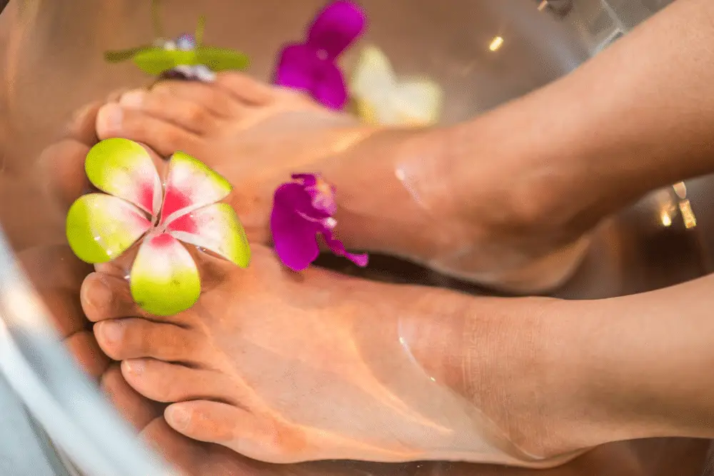 A woman soaking her feet before a custom massage in Minneapolis