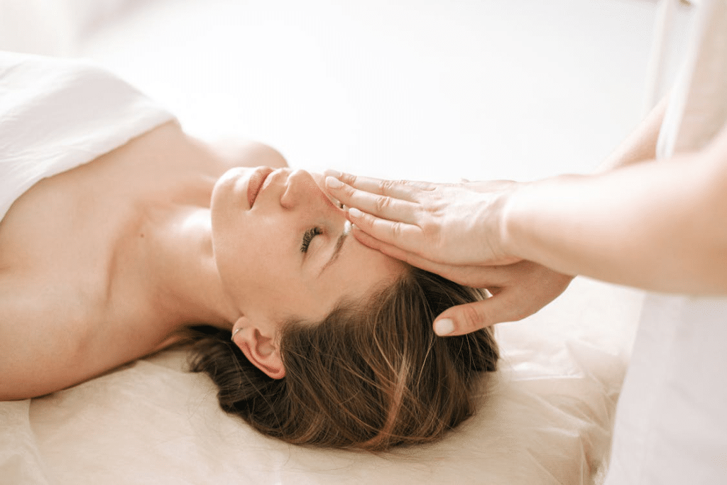 A person getting a scalp massage with a skilled therapist