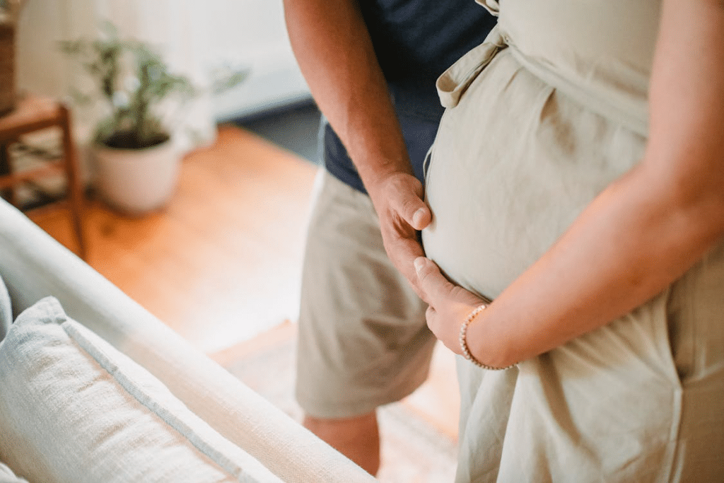 Cropped photo of a pregnant couple holding the belly