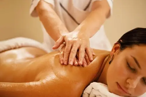 a person massaging a shoulder