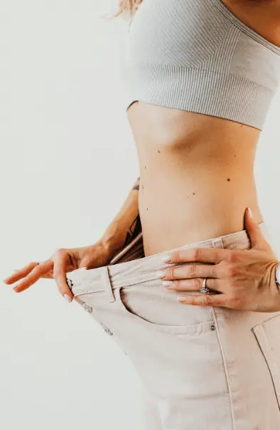 A woman wearing loose pants after getting body contouring in Minneapolis.