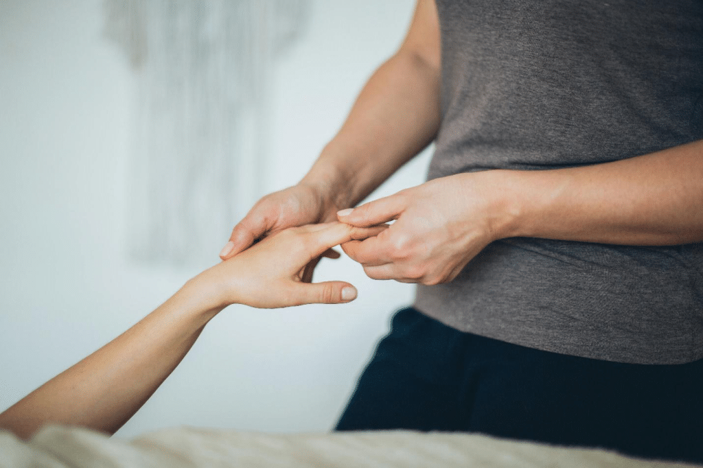 A picture of a hand of a person getting a hand massage