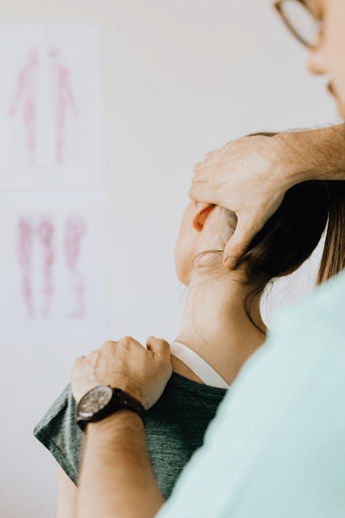 A close-up of a therapist massaging a client’s shoulder to relieve morning stiffness.