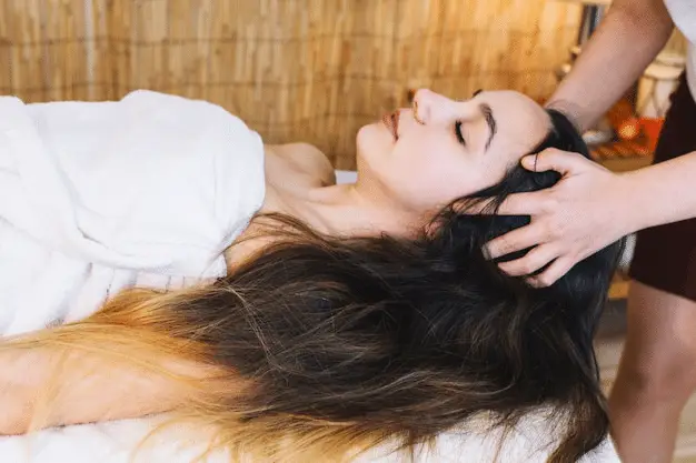 serene woman with long dark hair enjoying a spa treatment