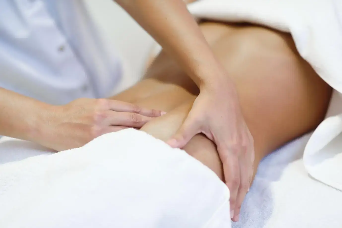 Massage therapist performing fascia release on a client’s back