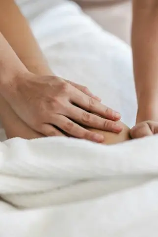 Close-up of hands giving a gentle massage.
