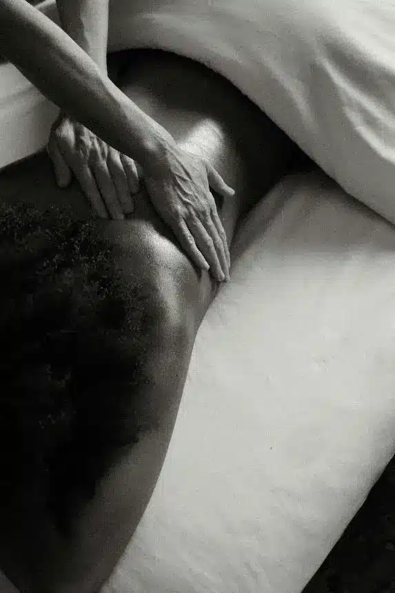 Therapist performing a gentle back massage to stimulate circulation.