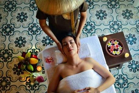 Woman receiving a calming head and neck massage in a spa setting