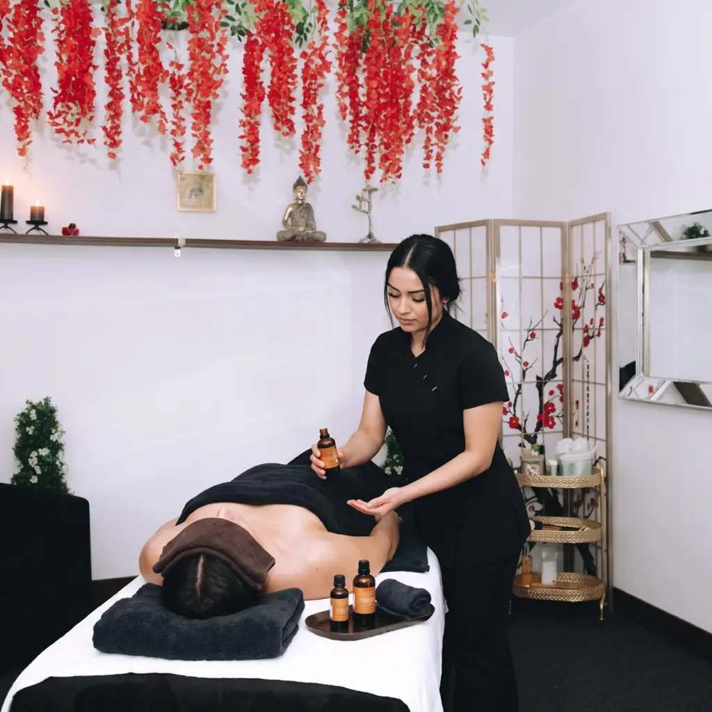 Comfort-focused side massage in the blue floral Master of Massage treatment room in Minneapolis